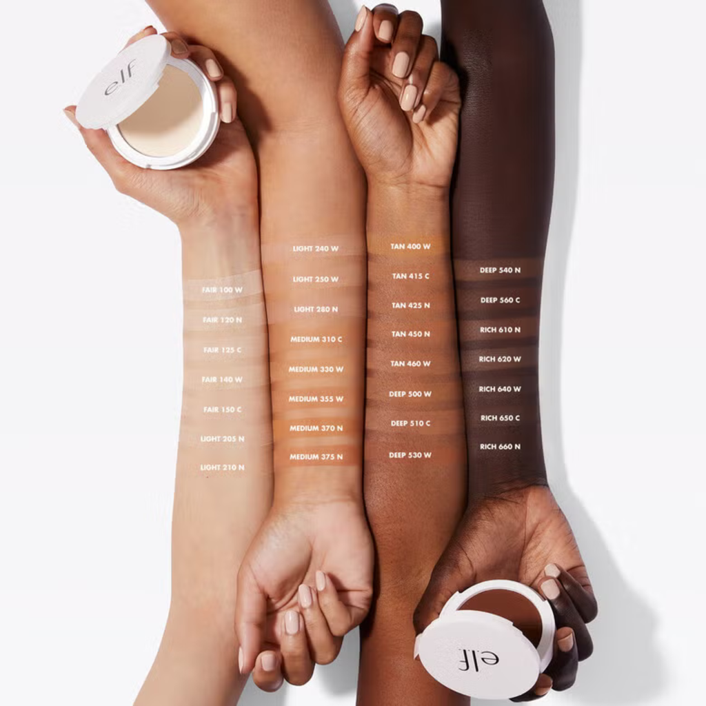 Three arms with different skin tones holding ELF foundation pots and swatches on a white background