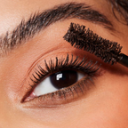 Model applying e.l.f. Big Mood Mascara for volumized lashes