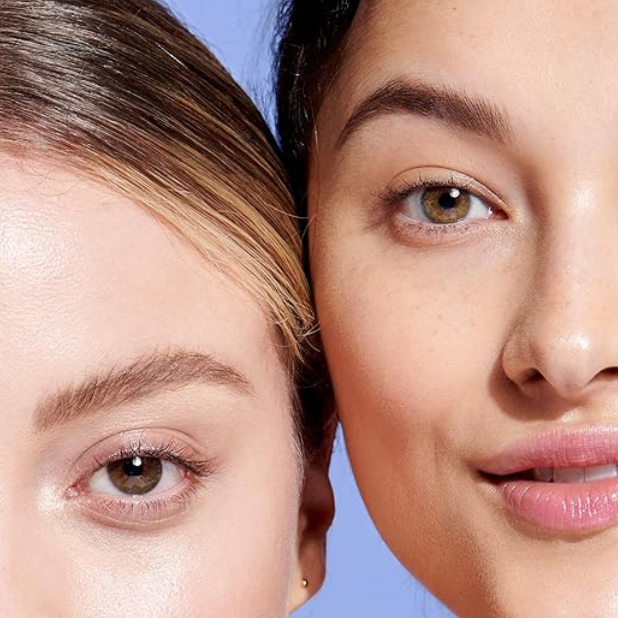 Close-up of two women's faces with a blue background